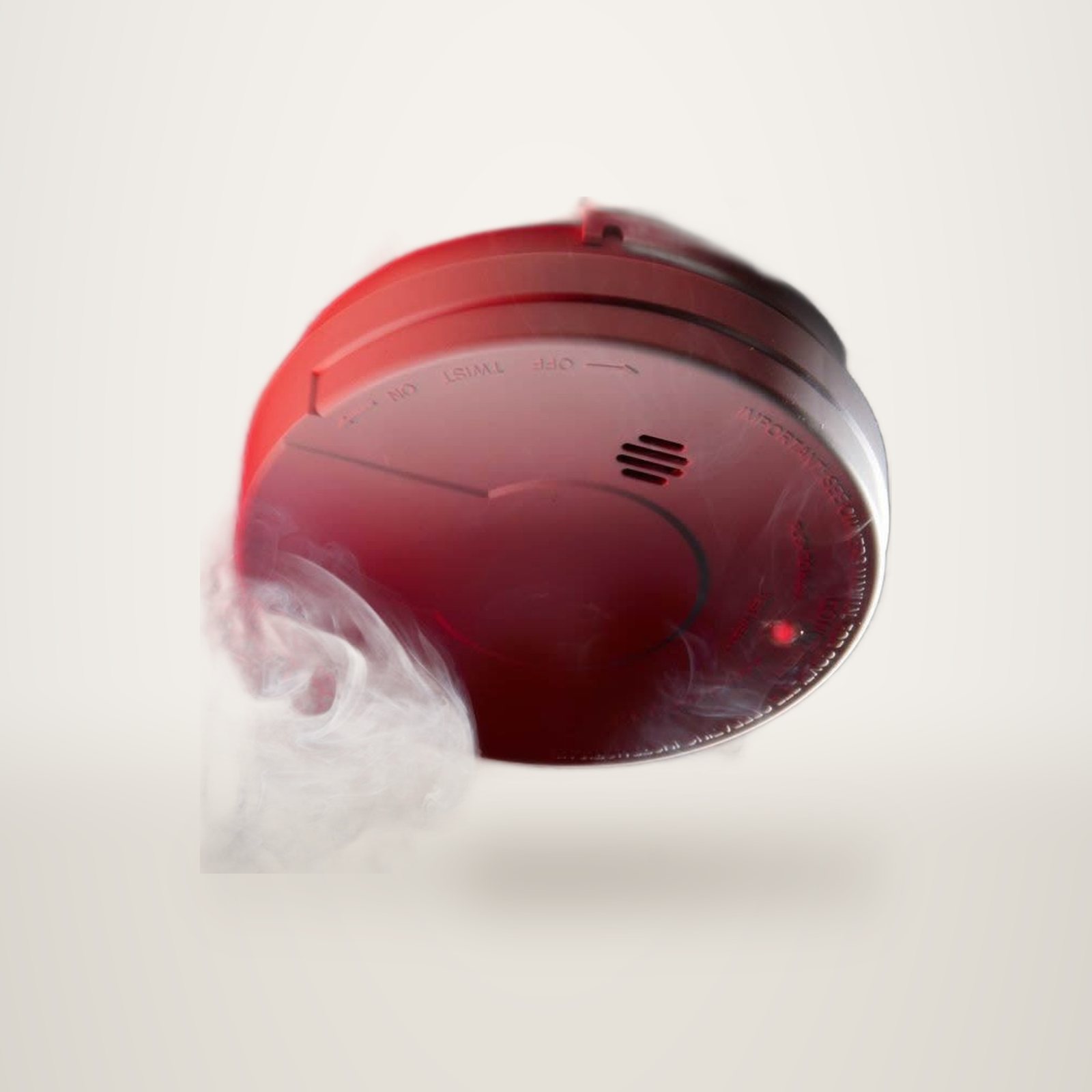 Un détecteur de fumée rouge fixé au plafond, entouré de volutes de fumée.
